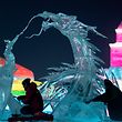 Ice sculptors give finishing touches on an ice sculpture at the Harbin Ice and Snow World festival in Harbin, in China's northeast Heilongjiang province on January 3, 2020. (Photo by NOEL CELIS / AFP)