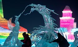 Ice sculptors give finishing touches on an ice sculpture at the Harbin Ice and Snow World festival in Harbin, in China's northeast Heilongjiang province on January 3, 2020. (Photo by NOEL CELIS / AFP)