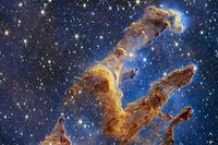 This handout photo provided by NASA on October 19, 2022 shows the Pillars of Creation that are set off in a kaleidoscope of color in NASA�s James Webb Space Telescope�s near-infrared-light view. - The pillars look like arches and spires rising out of a desert landscape, but are filled with semi-transparent gas and dust, and ever changing. This is a region where young stars are forming � or have barely burst from their dusty cocoons as they continue to form. (Photo by Handout / NASA/ESA/CSA / AFP) / RESTRICTED TO EDITORIAL USE - MANDATORY CREDIT "AFP PHOTO / NASA/ESA/CSA " - NO MARKETING NO ADVERTISING CAMPAIGNS - DISTRIBUTED AS A SERVICE TO CLIENTS