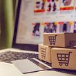 Shopping online concept - Shopping service on The online web. with payment by credit card and offers home delivery. parcel or Paper cartons with a shopping cart logo on a laptop keyboard