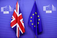 This picture taken on December 9, 2020, shows flags of the Union Jack and the EU ahead of Britain's Prime Minister's meeting on post Brexit trade deal with European Commission President, in Brussels. - Britain's Prime Minister arrives in Brussels on December 9, 2020, with hopes for a post-Brexit trade deal hanging on crisis talks with EU chief. Talks are blocked over the issue of fair competition, with Britain refusing to accept a mechanism that would allow the EU to respond swiftly if UK and EU business rules diverge over time and put European firms at a disadvantage. (Photo by Olivier HOSLET / POOL / AFP)