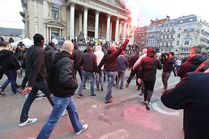 A group of people disturb the rally around the makeshift memorial in tribute to the victims of the Brussels terror attacks, on Place de la Bourse square in Brussels on March 27, 2016 while the planned citizens march was cancelled for safety reasons at the request of the government As mourners gathered at a square in central Brussels which has been transformed into a shrine to the victims of March 22 attacks on the airport and the metro system, prosecutors said they had charged a second man with involvement in a terror group over a foiled plot to strike France. It was the latest piece in the puzzle of the jihadist networks straddling France and Belgium. / AFP PHOTO / Belga / NICOLAS MAETERLINCK / Belgium OUT