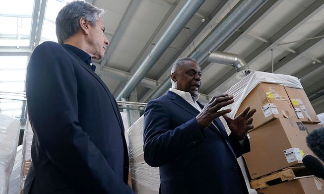 Pallets of aid to Ukraine are stacked behind US Defense Secretary Lloyd Austin (R) and Secretary of State Antony Blinken (L) as they speak with reporters after returning from their trip to Kyiv, Ukraine, on Sunday.