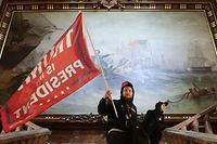 WASHINGTON, DC - JANUARY 06: A protester holds a Trump flag inside the US Capitol Building near the Senate Chamber on January 06, 2021 in Washington, DC. Congress held a joint session today to ratify President-elect Joe Biden's 306-232 Electoral College win over President Donald Trump. A group of Republican senators said they would reject the Electoral College votes of several states unless Congress appointed a commission to audit the election results.   Win McNamee/Getty Images/AFP
== FOR NEWSPAPERS, INTERNET, TELCOS & TELEVISION USE ONLY ==