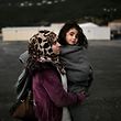 A woman from Syria holds her baby as she arrives at the registration centre on the Greek island of Samos, after being rescued by the charity Migrant Offshore Aid Station (MOAS) while attempting to reach the Greek island of Agathonisi, in Dodecanese, southeastern Aegean Sea, overnight on January 16, 2016. 
Maltese-based NGO MOAS (Migrant Offshore Aid Station) rescued 48 migrants and refugees near the Agathonisi island.  / AFP / ANGELOS TZORTZINIS