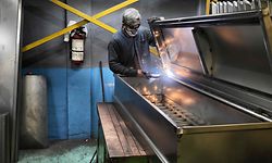 Daniel Cadena works at the Litomex steel coffin factory in Ecatepec, Mexico state, Mexico on January 26, 2021. - The chilling increase in deaths from the pandemic has overwhelmed the country's hospitals, funeral homes, cemeteries and crematoriums. The coronavirus has killed at least 158,536 people in Mexico by the end of January 2021 since the outbreak emerged in China in December 2019. (Photo by Alfredo ESTRELLA / AFP)