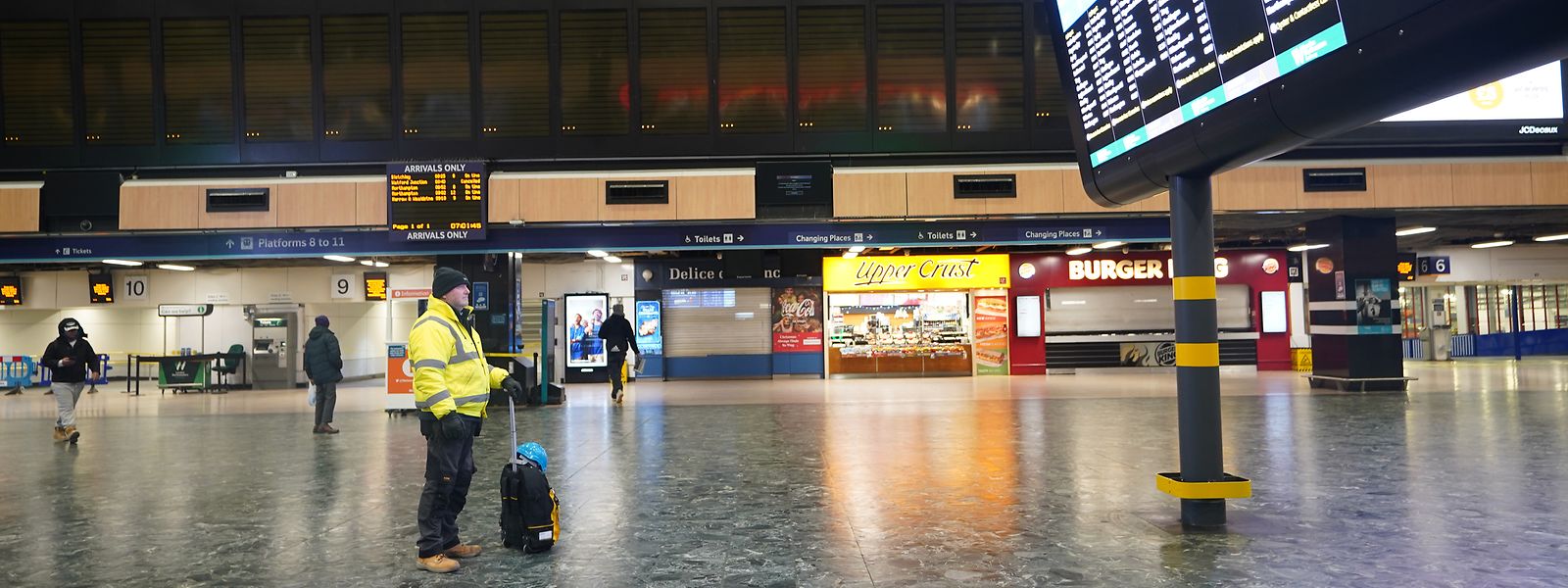 Ein Mann betrachtet die Abfahrtstafel im Bahnhof Euston in London während eines Streiks. Das öffentliche Leben steht still.