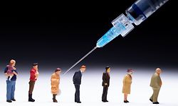 This picture taken on January 5, 2021, in Paris, shows figurines and a syringe to illustrate people receiving Covid-19 (novel coronavirus) vaccinations. - EU nations started their Covid-19 vaccination campaigns with their most vulnerable groups on December 27, 2020, as a new coronavirus variant spread internationally and the WHO warned the current pandemic will not be the last. (Photo by JOEL SAGET / AFP)