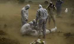 EDITORS NOTE: Graphic content / -- AFP PICTURES OF THE YEAR 2020 --

Relatives wearing protective gear tie up the dead body of a victim who died from the COVID-19 coronavirus before the burial at a graveyard in New Delhi on May 10, 2020. (Photo by SAJJAD HUSSAIN / AFP)