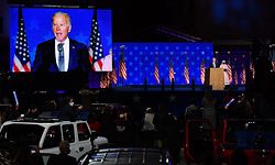 Supporters of Democratic presidential nominee Joe Biden listen to him speak, next to his wife Jill Biden, during election night at the Chase Center in Wilmington, Delaware, early on November 4, 2020. - Democrat Joe Biden said early Wednesday he believes he is "on track" to defeating US President Donald Trump, and called for Americans to have patience with vote-counting as several swing states remain up in the air.
"We believe we are on track to win this election," Biden told supporters in nationally broadcast remarks delivered in his home city of Wilmington, Delaware, adding: "It ain't over until every vote is counted." (Photo by ANGELA WEISS / AFP)