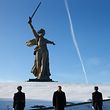 Russian President Vladimir Putin (C) attends a wreath laying ceremony at the eternal flame of the Mamayev Kurgan memorial complex in the city of Volgograd during an event to commemorate the 75th anniversary of the battle of Stalingrad on February 2, 2018. Russia marked 75 years since the Soviet Union's victory in the major World War II Battle of Stalingrad, extolled as a symbol of the country's resilience at a time when Putin campaigns for his fourth term. / AFP PHOTO / POOL / MAXIM SHEMETOV