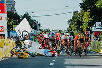 Dutch cyclist Fabio Jakobsen's bicycle (behind,L) flies through the air as he collides with compatriot Dylan Groenewegen (on the ground ,L) during the opening stage of the Tour of Poland race in Katowice , southern Poland on August 5, 2020. - The Dutch rider was fighting for his life on Wednesday after he was thrown into and over a barrier at 80km/h in a sickening conclusion to the opening stage of the Tour of Poland. (Photo by Szymon Gruchalski / Forum / AFP)