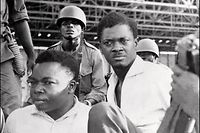(FILES) In this file photo taken on November 1, 1960, soldiers guard Patrice Lumumba (R), Prime Minister of then Congo-Kinshasa, and Joseph Okito (L), vice-president of the Senate, upon their arrest in December 1960 in Leopoldville (now Kinshasa). - The Democratic Republic of Congo celebrates the 60th anniversary of its independance from Belgium on June 30, 2020. Leader of the Congolese national movement, Patrice Lumumba became the first Prime Minister (1960) of the new state Democatic Republic of the Congo, former Belgian Congo, renammed Zaire in 1971. Arrested in November 1960 and deposed, he was assassinated in January 1961. (Photo by - / AFP)