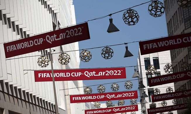 World Cup banners hang over the street in Doha on November 14, 2022 ahead of the Qatar 2022 FIFA World Cup football tournament