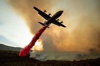 (FILES) In this file photo taken on August 05, 2018 An air tanker drops retardant on the Ranch Fire, part of the Mendocino Complex Fire, burning along High Valley Rd near Clearlake Oaks, California.
Two blazes mercilessly charring northern California have grown so rapidly that they became the US state's largest in recorded history Monday August 6, 2018, authorities said. / AFP PHOTO / NOAH BERGER
