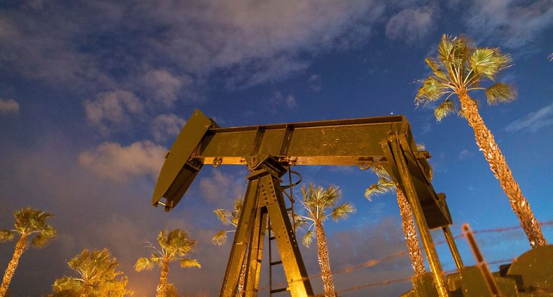 (FILES) In this file photo pump jacks draw crude oil from the Long Beach Oil Field under Discovery Well Park in Signal Hill, California, on March 9, 2020. - The US benchmark crude oil price sank to its lowest level ever on April 20, 2020, falling below $5 a barrel amid an epic supply glut and the coronavirus pandemic's hit to demand. After twice beating the record low, dropping to $4.04, West Texas Intermediate (WTI) for May delivery had recovered slightly at about 1720 GMT, and was trading at $5.18 a barrel in New York. (Photo by DAVID MCNEW / AFP)