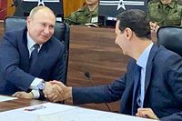 A handout picture released by the official Syrian presidency Telegram page on January 7, 2020 shows President Bashar al-Assad (C-R) shaking the hand of his Russian counterpart Vladimir Putin (C-L) at the headquarters of the Russian forces in the Syrian capital Damascus. (Photo by - / various sources / AFP) / == RESTRICTED TO EDITORIAL USE - MANDATORY CREDIT "AFP PHOTO / HO / SYRIAN PRESIDENCY TELEGRAM PAGE" - NO MARKETING NO ADVERTISING CAMPAIGNS - DISTRIBUTED AS A SERVICE TO CLIENTS ==