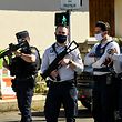French police officials block off a street near a police station in Rambouillet, south-west of Paris, on April 23, 2021, after a woman was stabbed to death. - A female police employee was stabbed to death by a Tunisian man at a police station southwest of Paris on Friday, the local prosecutor's office and a police source told AFP. The attacker was fatally wounded when an officer opened fire on him at the station in Rambouillet, a wealthy commuter town about 60 kilometres from Paris, a police source told AFP. (Photo by Bertrand GUAY / AFP)