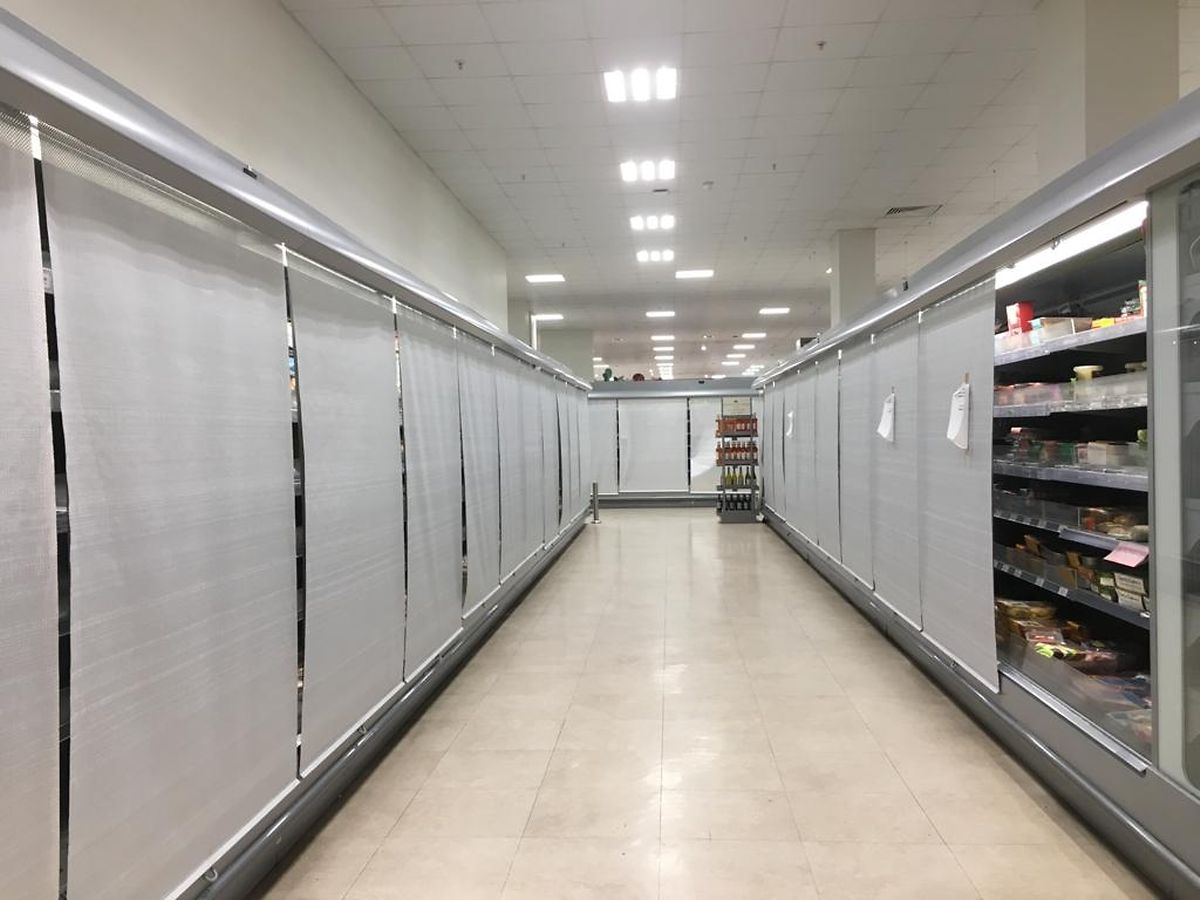A supermarket in London during a heatwave, keeping refrigerators cold behind blinds