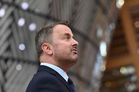 Luxembourg's Prime Minister Xavier Bettel addresses media representatives as he arrives on the first day of a European Union (EU) summit at The European Council Building in Brussels on June 24, 2021. - . (Photo by JOHN THYS / POOL / AFP)