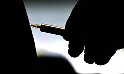 A woman receives a jab of the AstraZeneca/Oxford vaccine at a coronavirus vaccination centre at the Wizink Center in Madrid on May 12, 2021. - With nearly 79,000 deaths and more than 3.5 million infections, Spain has been badly hit by the pandemic. (Photo by GABRIEL BOUYS / AFP)