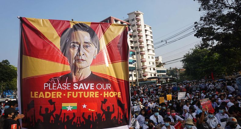 st(FILES) In this file photo taken on February 15, 2021 a banner featuring Aung San Suu Kyi is displayed as protesters take part in a demonstration against the military coup in front of the National League for Democracy (NLD) office in Yangon. - Myanmar's junta-stacked election commission announced on March 28, 2023 that Aung San Suu Kyi's National League for Democracy Party would be dissolved for failing to re-register under a tough new military-drafted electoral law, state media said. (Photo by AFP)