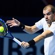 Luxembourg's Gilles Muller returns the ball to Bulgaria's Grigor Dimitrov during their tennis match at the Swiss Indoors tournament on October 25, 2016 in Basel. / AFP PHOTO / FABRICE COFFRINI