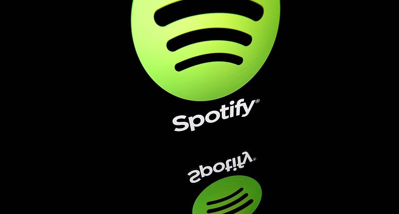 (FILES) This file photo illustration taken on April 19, 2018 in Paris shows the logo of online streaming music service Spotify displayed on a tablet screen. - Music streaming giant Spotify on January 31, 2023 reported a total of 205 million paying subscribers at the end of 2022, beating expectations, but its losses deepened. (Photo by Lionel BONAVENTURE / AFP)