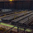An employee looks at 108-metre rails for high-speed rail networks during the 2011 inauguration of the facility in the French town of Hayange. 