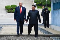 (FILES) In this file photo taken on June 30, 2019 North Korea's leader Kim Jong Un and US President Donald Trump cross south of the Military Demarcation Line that divides North and South Korea, after Trump briefly stepped over to the northern side, in the Joint Security Area (JSA) of Panmunjom in the Demilitarized zone (DMZ). - President Donald Trump warned on December 8, 2019 that North Korea's Kim Jong Un had "everything" to lose through hostility towards the United States, after Pyongyang said it had carried out a major new weapons test (Photo by Brendan Smialowski / AFP)