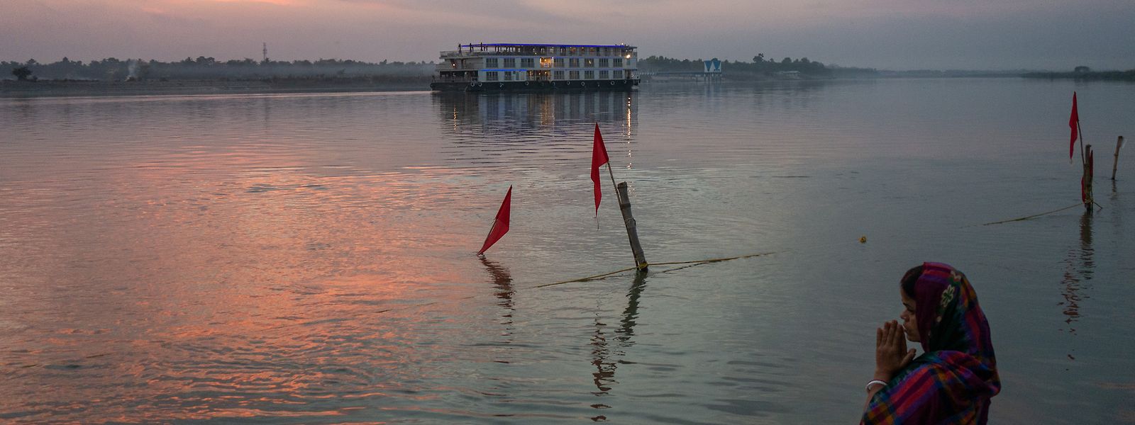 Betende Frau am Ufer in Mayapur - im Hintergrund das Flussschiff «Ganges Voyager».