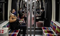 People wearing face masks commute in a metro train on May 4, 2020, in Paris, on the 49th day of a lockdown in France aimed at curbing the spread of COVID-19, caused by the novel coronavirus. (Photo by Christophe ARCHAMBAULT / AFP)