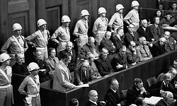 Hermann Goering, founder of the Gestapo and former head of the Luftwaffe, stands in the prisoners' dock to make his final statement to the court at the Nuremberg war crimes trials. He was convicted of crimes and sentenced to death, but killed himself with a concealed poison capsule just hours before he was to be hanged. (Photo by © CORBIS/Corbis via Getty Images)
