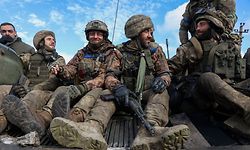 Ukrainian soldiers sit atop a personnel armoured carrier on a road near Lyman, Donetsk region on October 4, 2022, amid the Russian invasion of Ukraine. - Ukraine's President Volodymyr Zelensky said on October 2, 2022 that Lyman, a key town located in one of four Ukrainian regions annexed by Russia, had been "cleared" of Moscow's troops. (Photo by Anatolii Stepanov / AFP)
