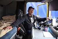 Lorry driver, Ivan Ivanov Petrov poses for a photograph in the cab of his parked-up freight truck at the Motis freight clearance centre after being delayed by over 24 hours at the port of Dover on the south coast of England on January 15, 2021, as hauliers get used to life under the post-Brexit trade deal. - British companies are struggling with a large amount of red tape as a result of Brexit, with senior government minister Michael Gove recently admitting that there would be "significant disruption" at the border because of increased bureaucracy that is slowing the flow of freight. (Photo by BEN STANSALL / AFP)