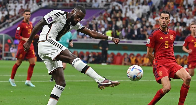 Germany's defender #02 Antonio Ruediger shoots the ball past Spain's midfielder #05 Sergio Busquets during the Qatar 2022 World Cup Group E football match between Spain and Germany at the Al-Bayt Stadium in Al Khor, north of Doha on November 27, 2022. (Photo by Glyn KIRK / AFP)