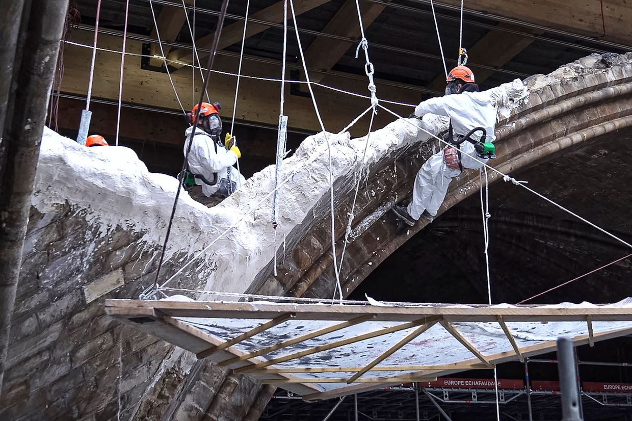 A grab from a video recorded by AFP on April 9, 2021 shows builders working on the restoration of the Notre-Dame Cathedral, in Paris, damaged by the April 15, 2019 fire. (Photo by Antoine BOUTHIER / AFP)