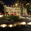 People hold a banner reading 'Je suis Bruxelles' (I am Brussels) in tribute to victims at a makeshift memorial in front of the stock exchange at the Place de la Bourse (Beursplein) in Brussels on March 22, 2016, following triple bomb attacks in the Belgian capital that killed about 35 people and left more than 200 people wounded. A series of explosions claimed by the Islamic State group ripped through Brussels airport and a metro train on March 22, killing around 35 people in the latest attacks to bring bloody carnage to the heart of Europe.  AFP PHOTO / KENZO TRIBOUILLARD