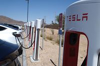 (FILES) In this file photo taken on May 14, 2022, Tesla cars sit at charging stations in Yermo, California. - Tesla reported a better-than-expected $2.3 billion in second-quarter earnings on July 20, 2022, despite a hit from Covid-19 lockdowns in Shanghai that weighed on profit margins. (Photo by Chris Delmas / AFP)
