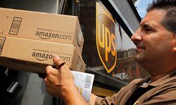 UPS driver T.J. Dellasala delivers two packages from Amazon.com in Boston, Massachusetts July 26, 2011.  Amazon.com Inc reported a surge in quarterly revenue on Tuesday while profit slipped as the largest Internet retailer benefited from growth in e-commerce but kept spending on distribution, technology and digital content. Second-quarter net income came in at $191 million, or 41 cents per share, versus $207 million, or 45 cents per share, in the same period a year earlier. Revenue was $9.91 billion, up 51 percent from a year ago.   REUTERS/Brian Snyder    (UNITED STATES - Tags: BUSINESS EMPLOYMENT)