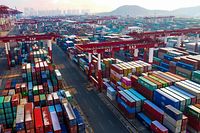Containers are seen stacked at a port in Qingdao in China's eastern Shandong province on January 14, 2020. - China's trade surplus with the United States narrowed last year as the world's two biggest economies exchanged punitive tariffs in a bruising trade war, official data showed on January 14, on the eve of a deal to ease tensions. (Photo by STR / AFP)