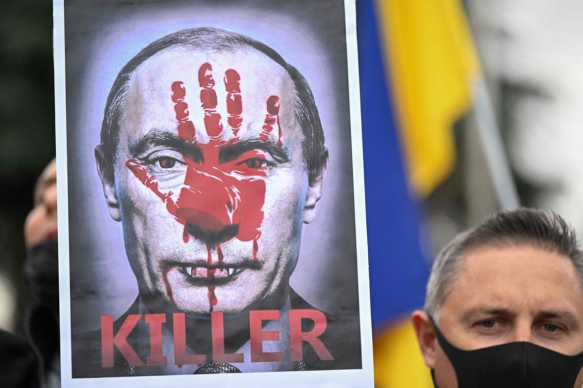 A demonstrator holds a sign depicting Russian President Vladimir Putin during a protest against Russia's invasion of Ukraine, in Madrid on Sunday.