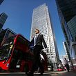 Pedestrians pass One Canada Square, which houses the European Banking Authority, in the Canary Wharf financial, business and shopping district in London, U.K., on Monday, July 31, 2017. On Tuesday, the European Union is due to announce the cities vying to host the London-based European Medicines Agency and the European Banking Authority after Brexit. Photographer: Chris Ratcliffe/Bloomberg via Getty Images  EBA LONDON