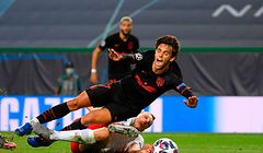 Atletico Madrid's Portuguese forward Joao Felix (L) is fouled by Leipzig's German defender Lukas Klostermann during the UEFA Champions League quarter-final football match between Leipzig and Atletico Madrid at the Jose Alvalade stadium in Lisbon on August 13, 2020. (Photo by LLUIS GENE / various sources / AFP)