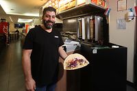 Snack Istanbul owner Izzet Karabulut showing a doner kebab, a relatively healthy type of fast food that has the added allure of being cheap