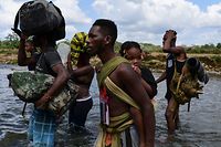 (File) Dalam file foto yang diambil pada 10 Februari 2021, para migran menyeberangi Sungai Chukonac setelah berjalan selama lima hari di Darien Gap, di desa Pajo Chiquito, Darien County, Panama, dalam perjalanan mereka ke Amerika Serikat.  Rekor jumlah anak-anak migran, banyak dari mereka tanpa pendamping, melintasi Hutan Darien antara Kolombia dan Panama tahun ini, lapor UNICEF pada 11 Oktober 2021 (Foto oleh Luis ACOSTA / AFP)