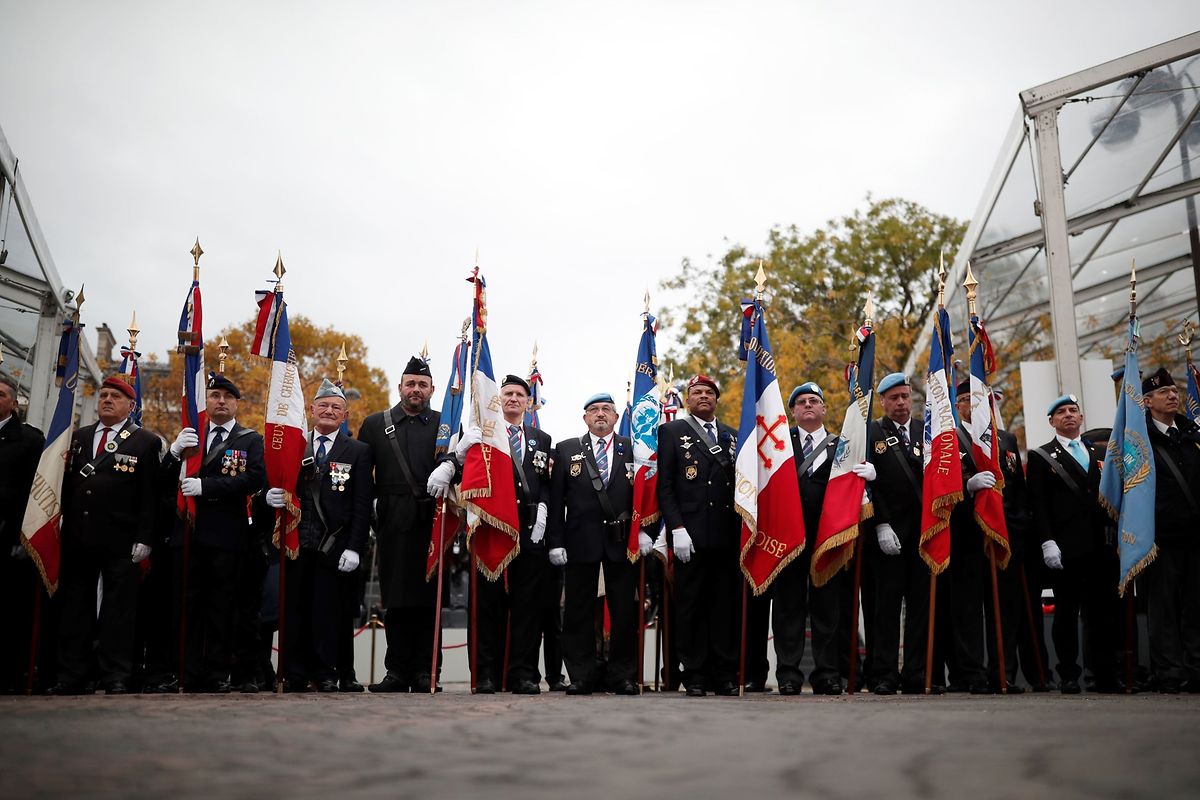 Veterans gather before a ceremony at the Arc de Triomphe in Paris on November 11, 2018 as part of commemorations marking the 100th anniversary of the 11 November 1918 armistice, ending World War I. (Photo by BENOIT TESSIER / POOL / AFP)