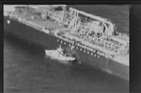 CORRECTION - This grab taken from a video released by the US Central Command (USCENTCOM) on June 13, 2019, reportedly shows an Iranian navy patrol boat in the Gulf of Oman approaching the Japanese operated methanol tanker Kokuka Courageous and removing an unexploded mine. (Photo by - / US Central Command (CENTCOM) / AFP) / RESTRICTED TO EDITORIAL USE - MANDATORY CREDIT "AFP PHOTO / USCENTCOM" - NO MARKETING NO ADVERTISING CAMPAIGNS - DISTRIBUTED AS A SERVICE TO CLIENTS / �The erroneous mention[s] appearing in the metadata of this photo by - has been modified in AFP systems in the following manner: [June 13] instead of [June 14]. Please immediately remove the erroneous mention[s] from all your online services and delete it (them) from your servers. If you have been authorized by AFP to distribute it (them) to third parties, please ensure that the same actions are carried out by them. Failure to promptly comply with these instructions will entail liability on your part for any continued or post notification usage. Therefore we thank you very much for all your attention and prompt action. We are sorry for the inconvenience this notification may cause and remain at your disposal for any further information you may require.�