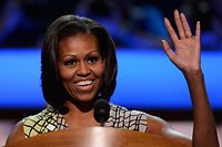 (FILES) In this file photo taken on September 3, 2012, First lady Michelle Obama waves at the podium during a soundcheck during preparations for the Democratic National Convention at Time Warner Cable Arena in Charlotte, North Carolina. - America's political convention season begins August 17, 2020 night with former first lady Michelle Obama addressing the Democrats' now-virtual gathering set to anoint Joe Biden, as President Donald Trump defies coronavirus concerns to rally supporters in battleground Wisconsin. (Photo by KEVORK DJANSEZIAN / GETTY IMAGES NORTH AMERICA / AFP)