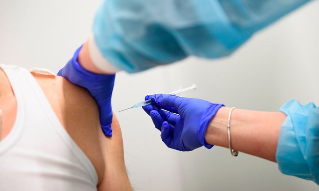 Healthcare staff administering a Covid-19 vaccine